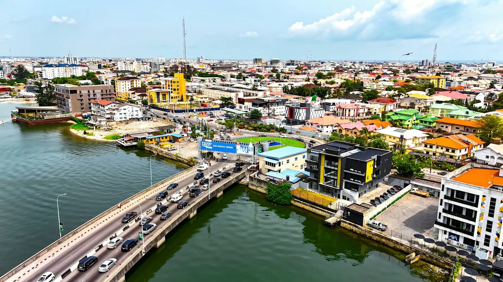 An aerial view of Lagos, with a bridge crossing the lagoon