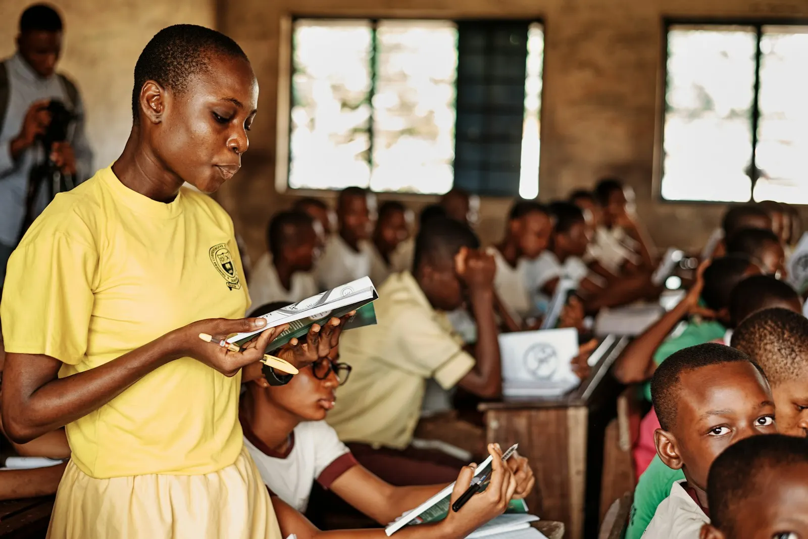 Pupils reading at their desks in a busy classroom