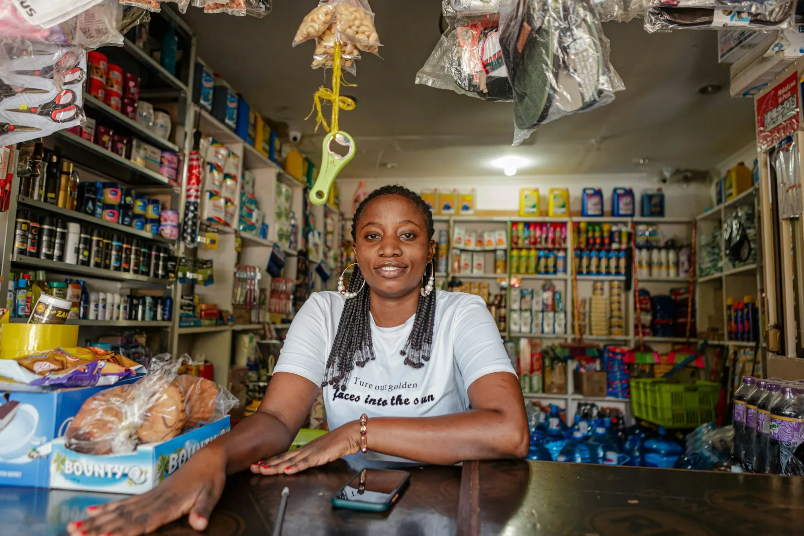 A shopkeeper at the counter of her general store